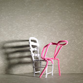Sad Pink stick figure sitting on a white chair