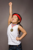 Girl wearing 1st place medal with arms in the air